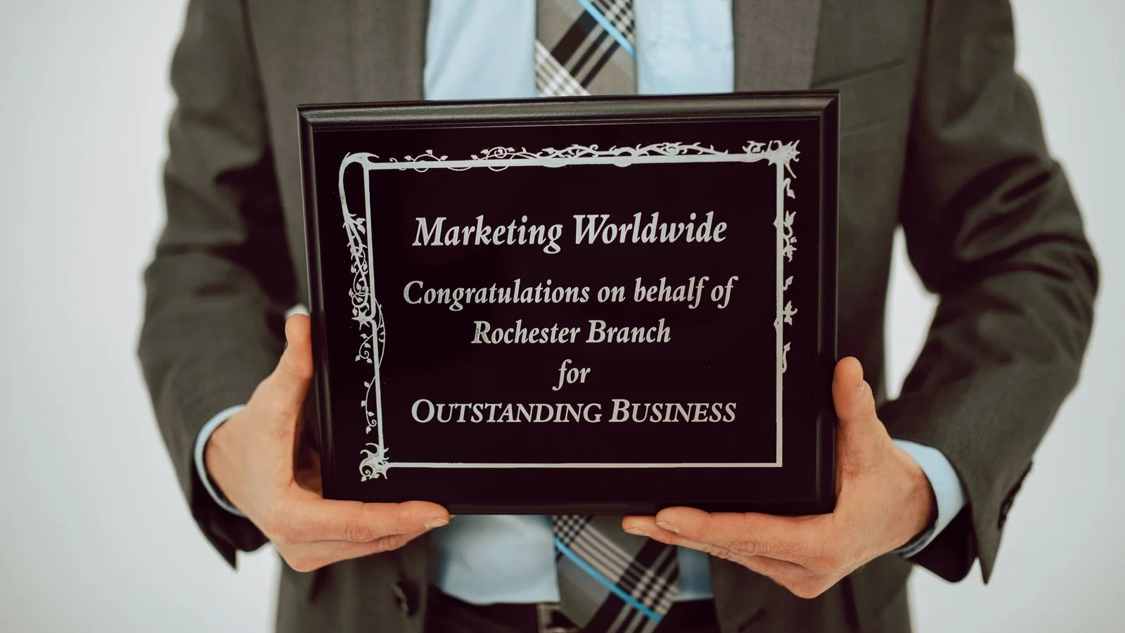 Businessperson holding an achievement award, the personal-growth story SUCCESS Magazine looks for