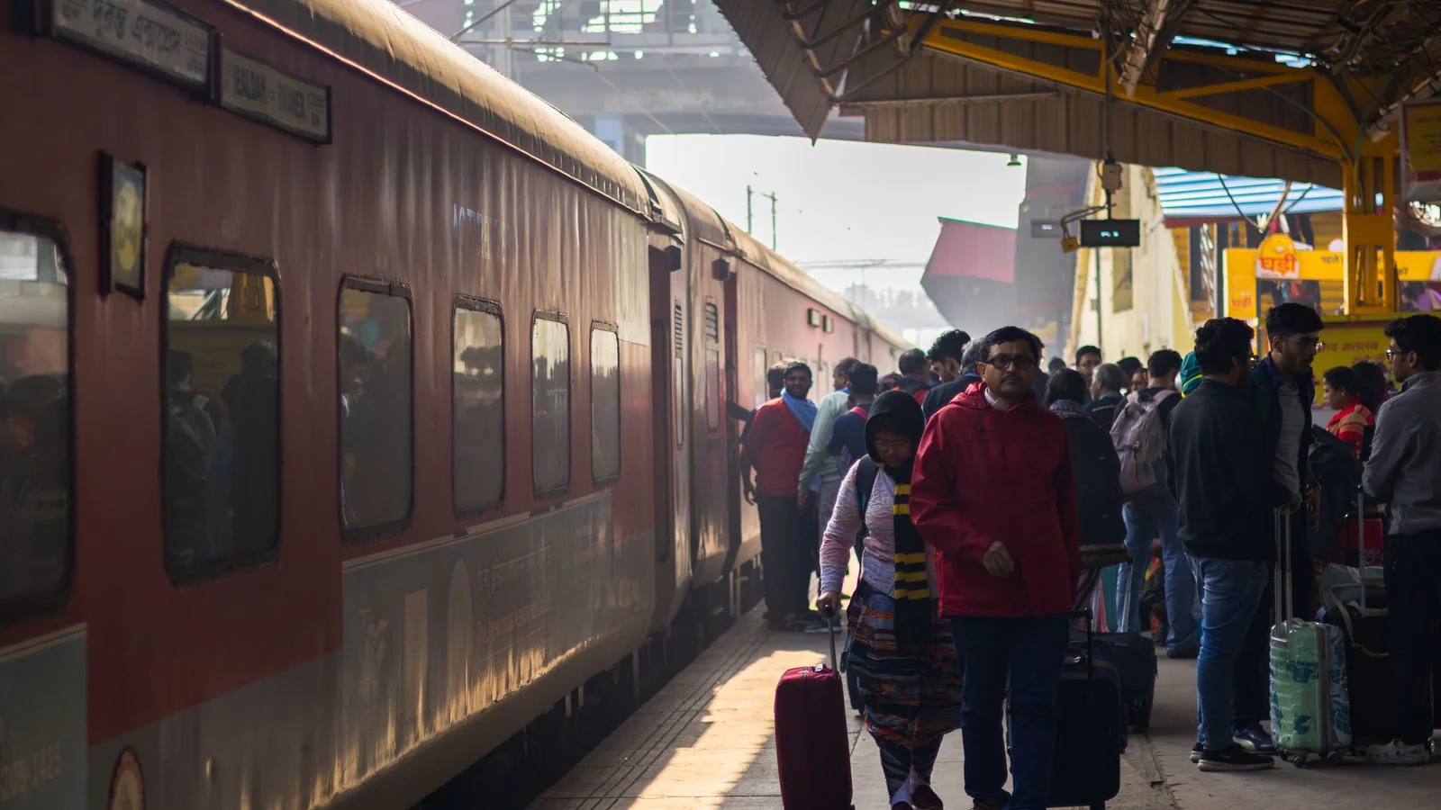 Commuters crowding an Indian railway station, the scale every national desk is triaging against