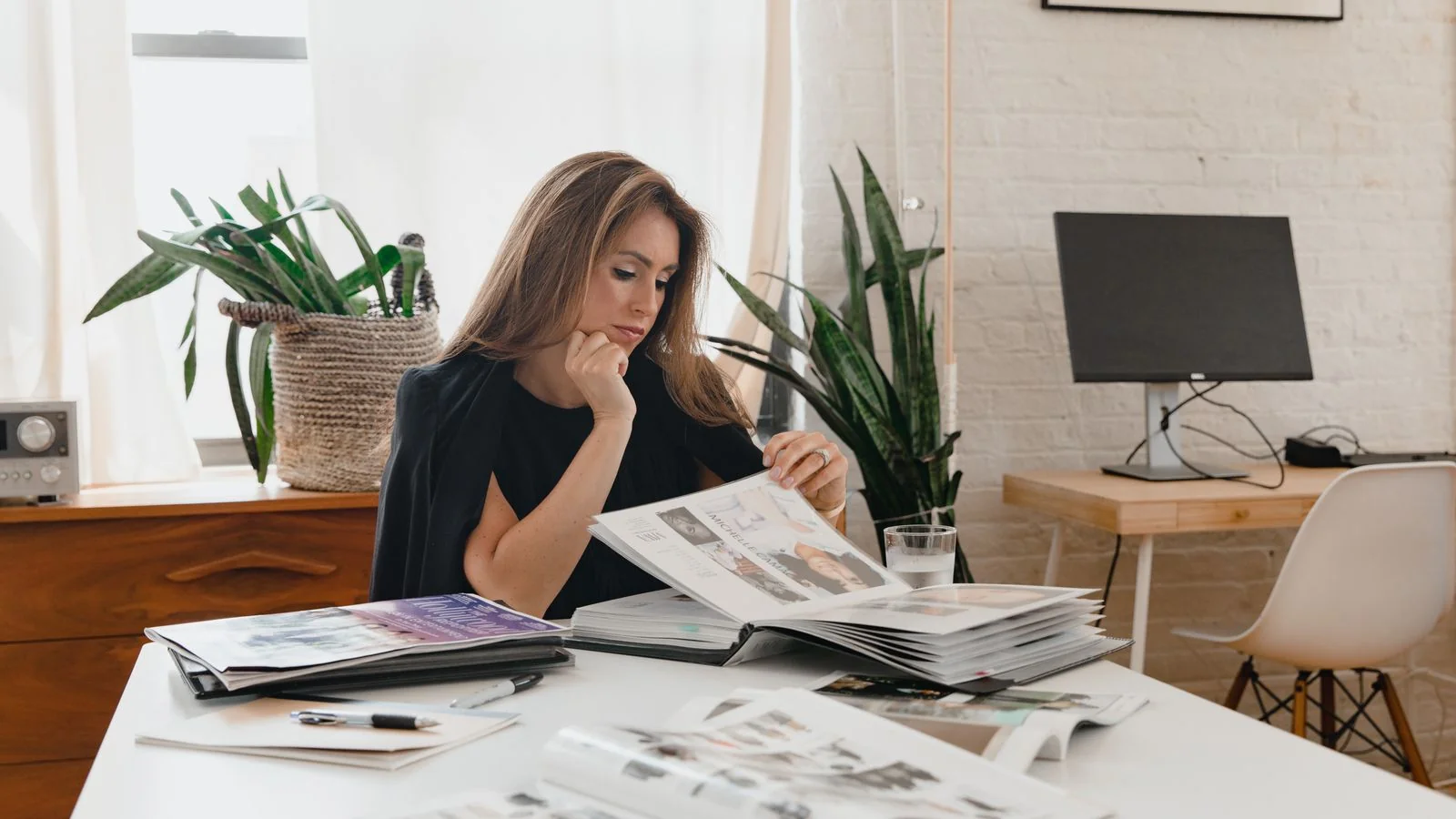 An editor reviewing pages at her desk, the point where pitches to Town & Country get triaged