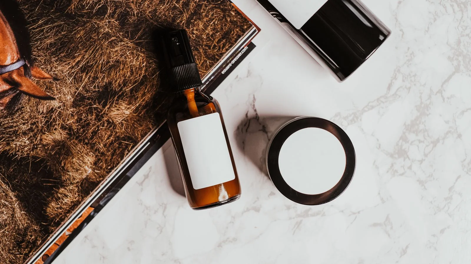 Skincare bottles on a marble surface, the product-adjacent editorial that supports the commerce side