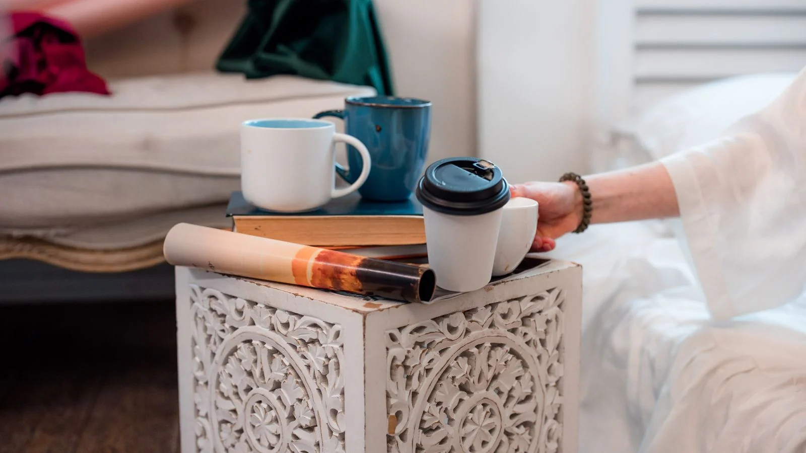 Coffee mugs and books on a decorated table, the home lifestyle world behind the Martha Stewart brand