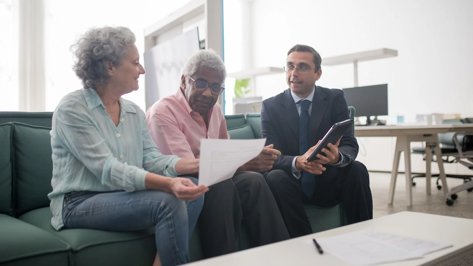 Senior couple reviewing documents with an advisor, the practitioner expertise a fact-checker needs to verify