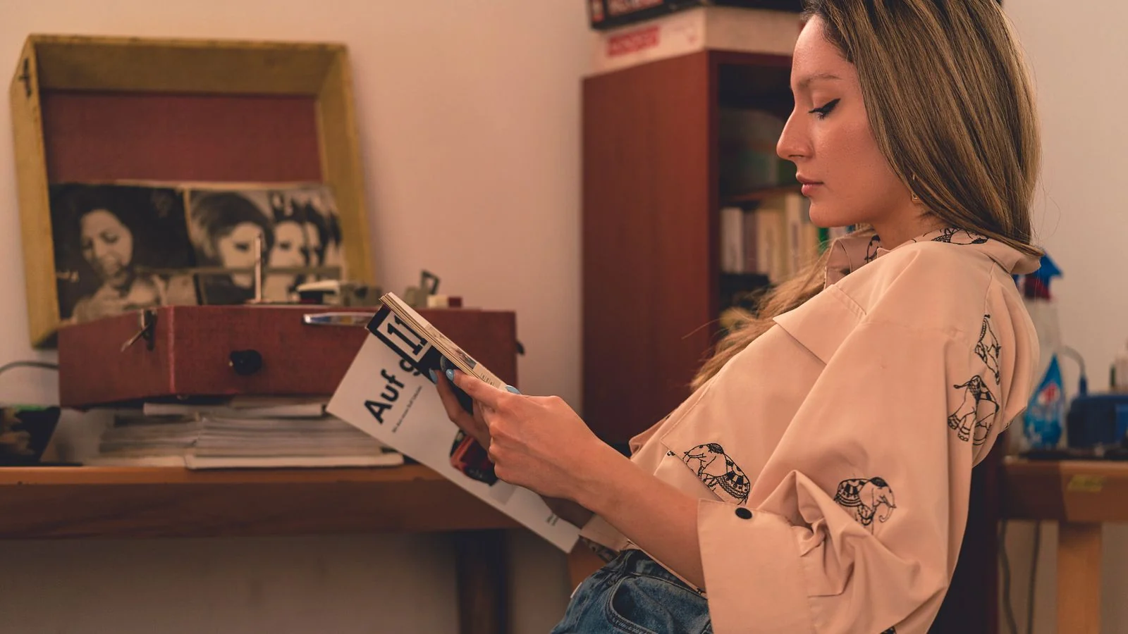 Woman reading a magazine at home in a vintage-styled room