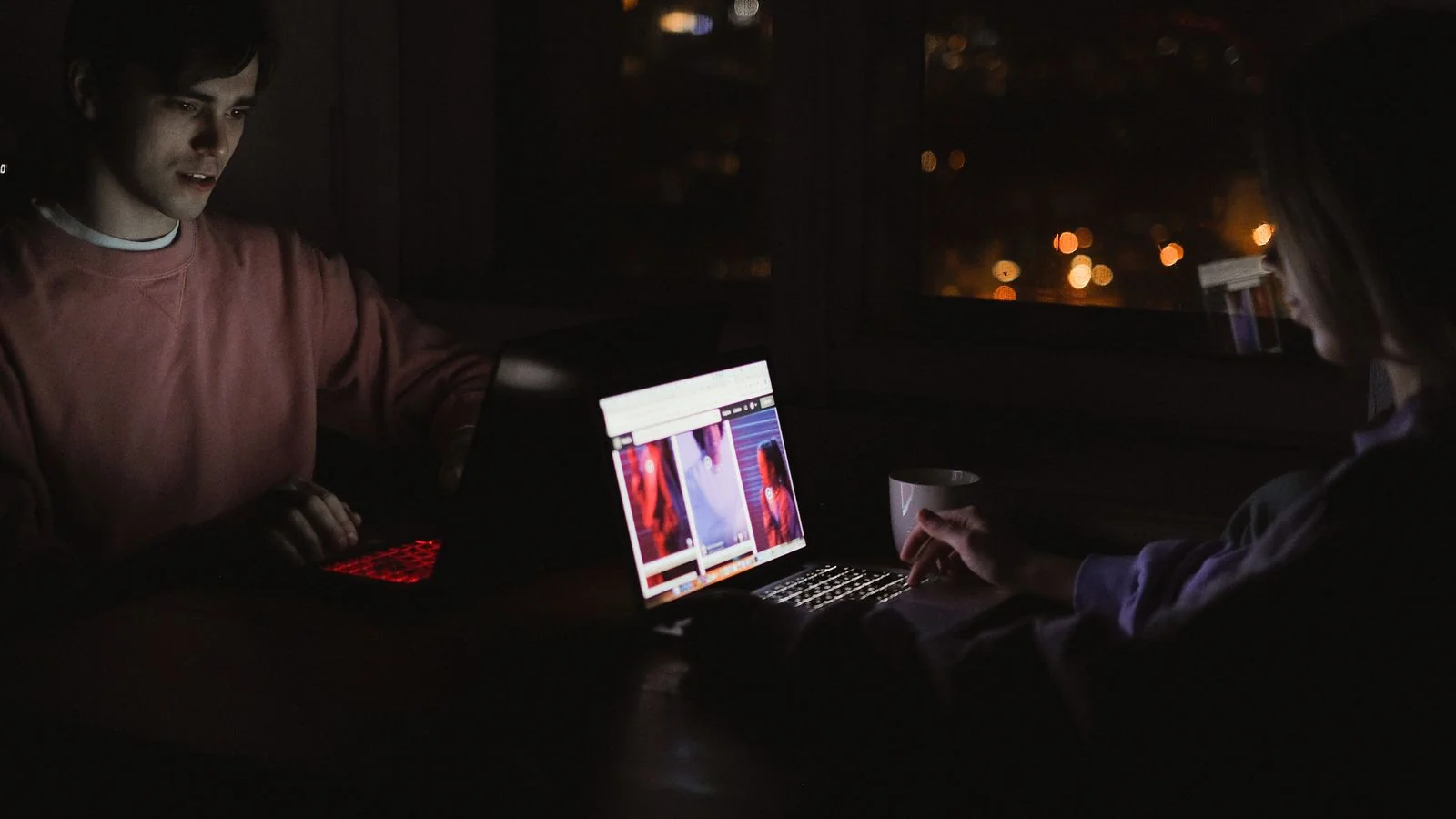 Two people working on laptops late at night, the hours a launch day actually takes