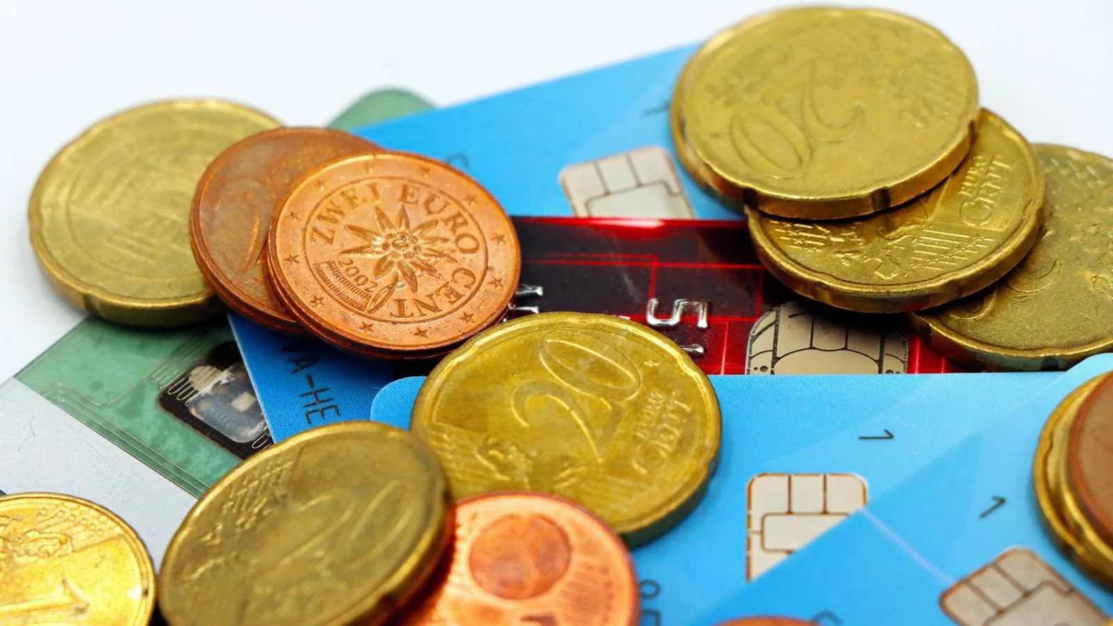 Euro coins and payment cards stacked together, the financial engine behind points coverage