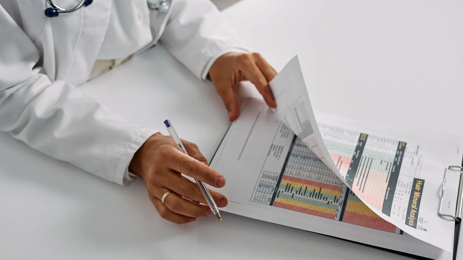 Medical professional checking patient reports on a clipboard in an office