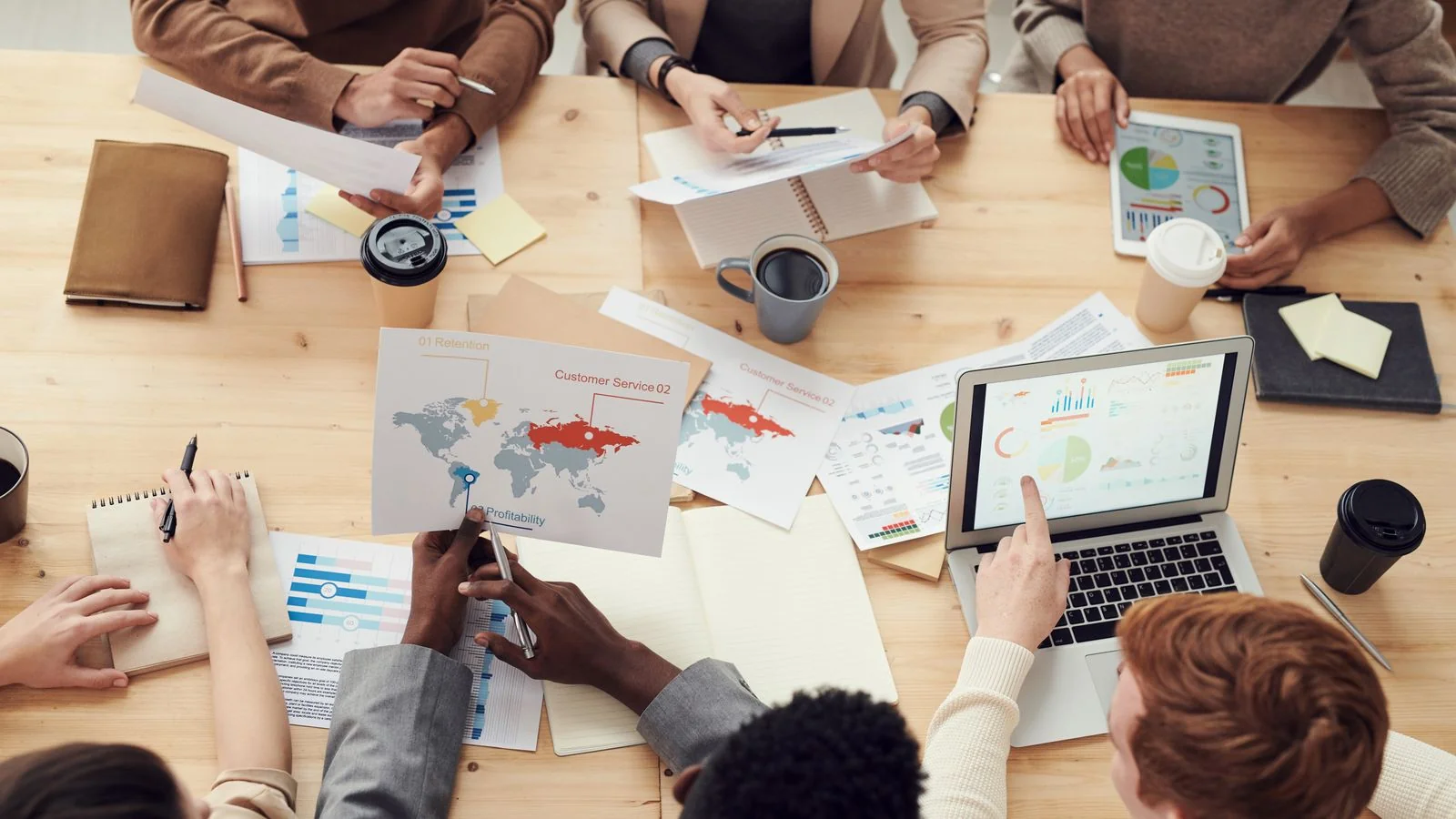 A marketing team in a content strategy meeting, the planning behind ranking for a full cluster of related questions
