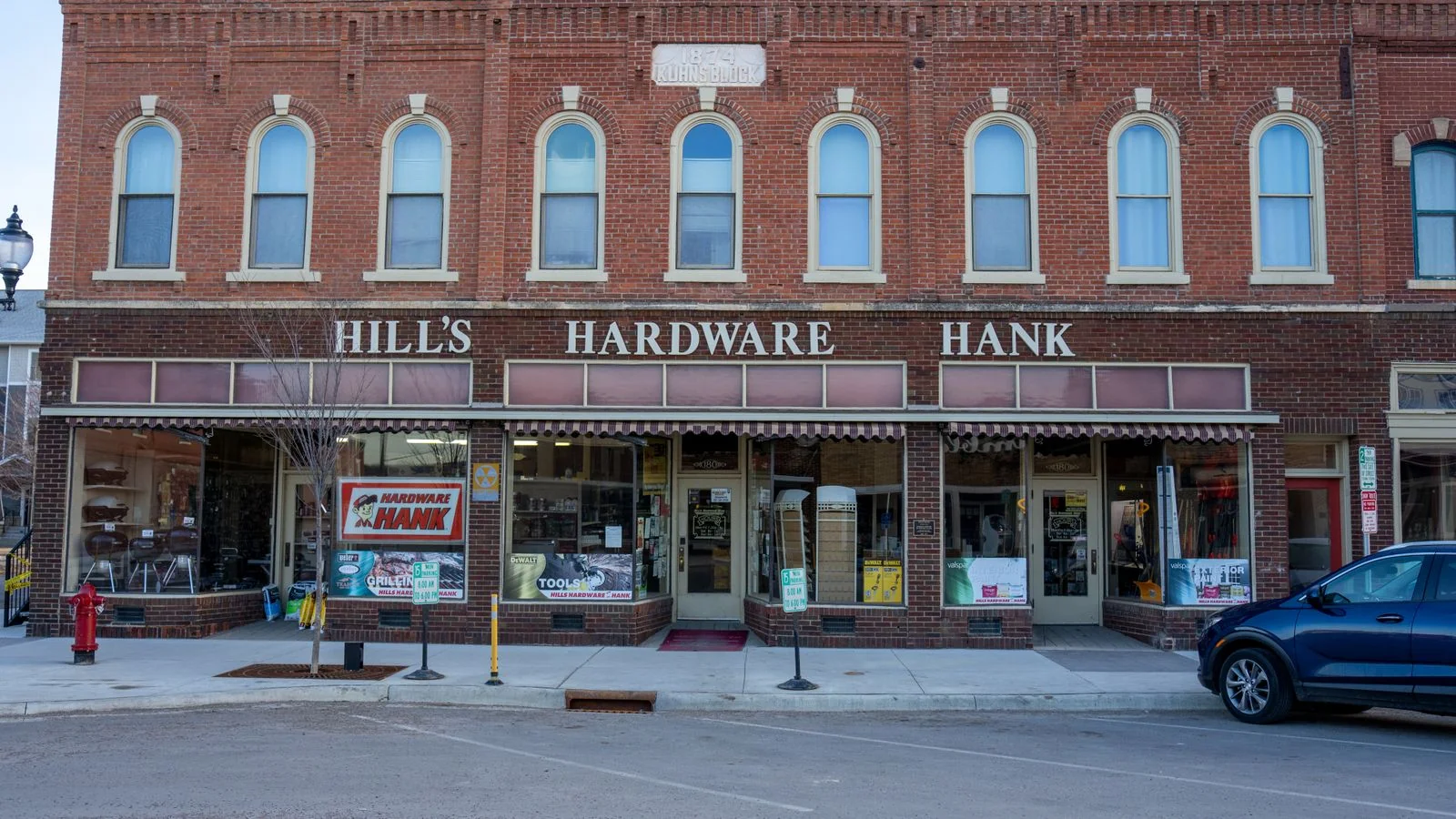 The brick storefront of a small-town hardware store, the kind of local business a metro reporter covers