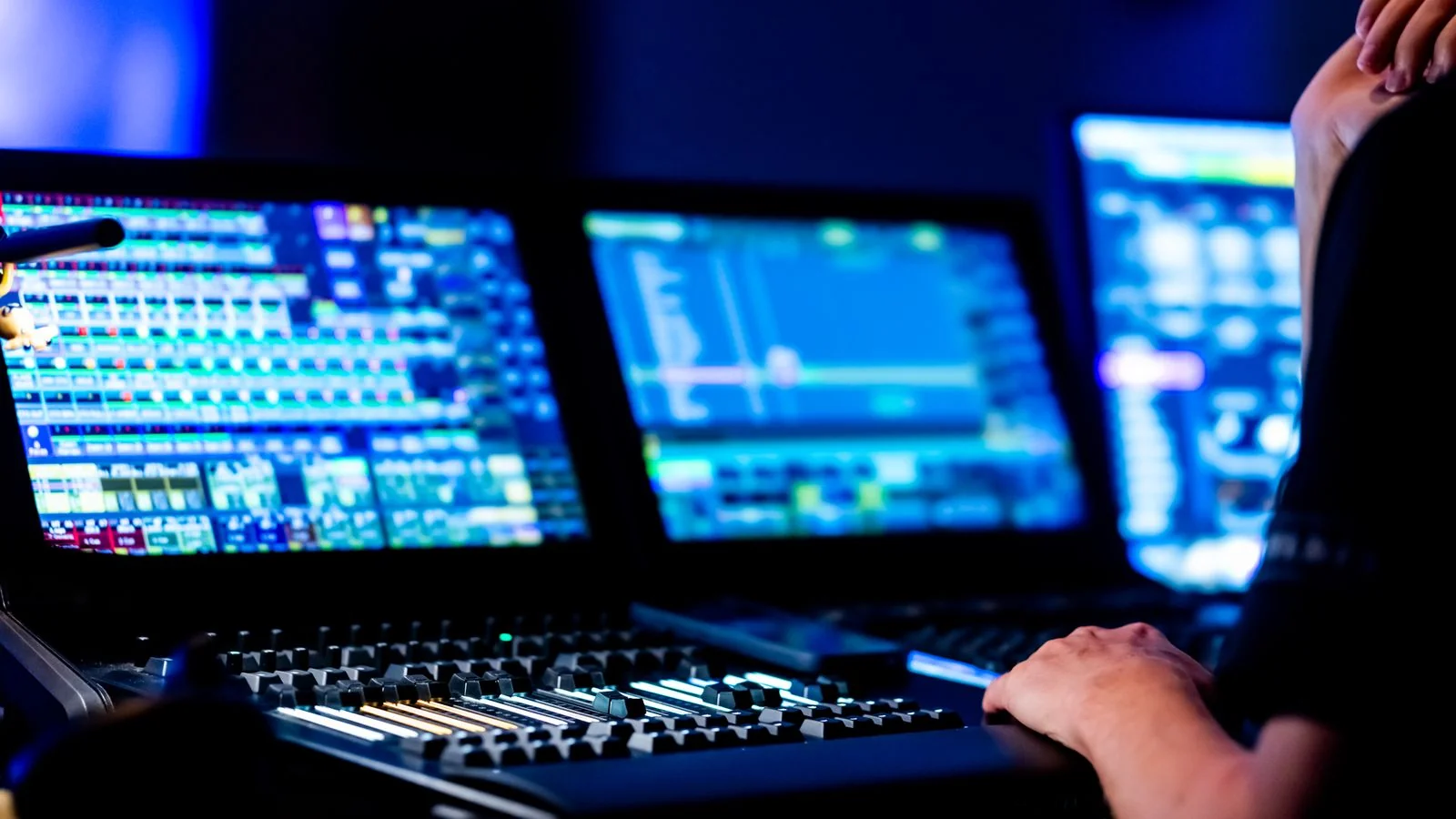 Sound engineer working a professional audio console in a control room