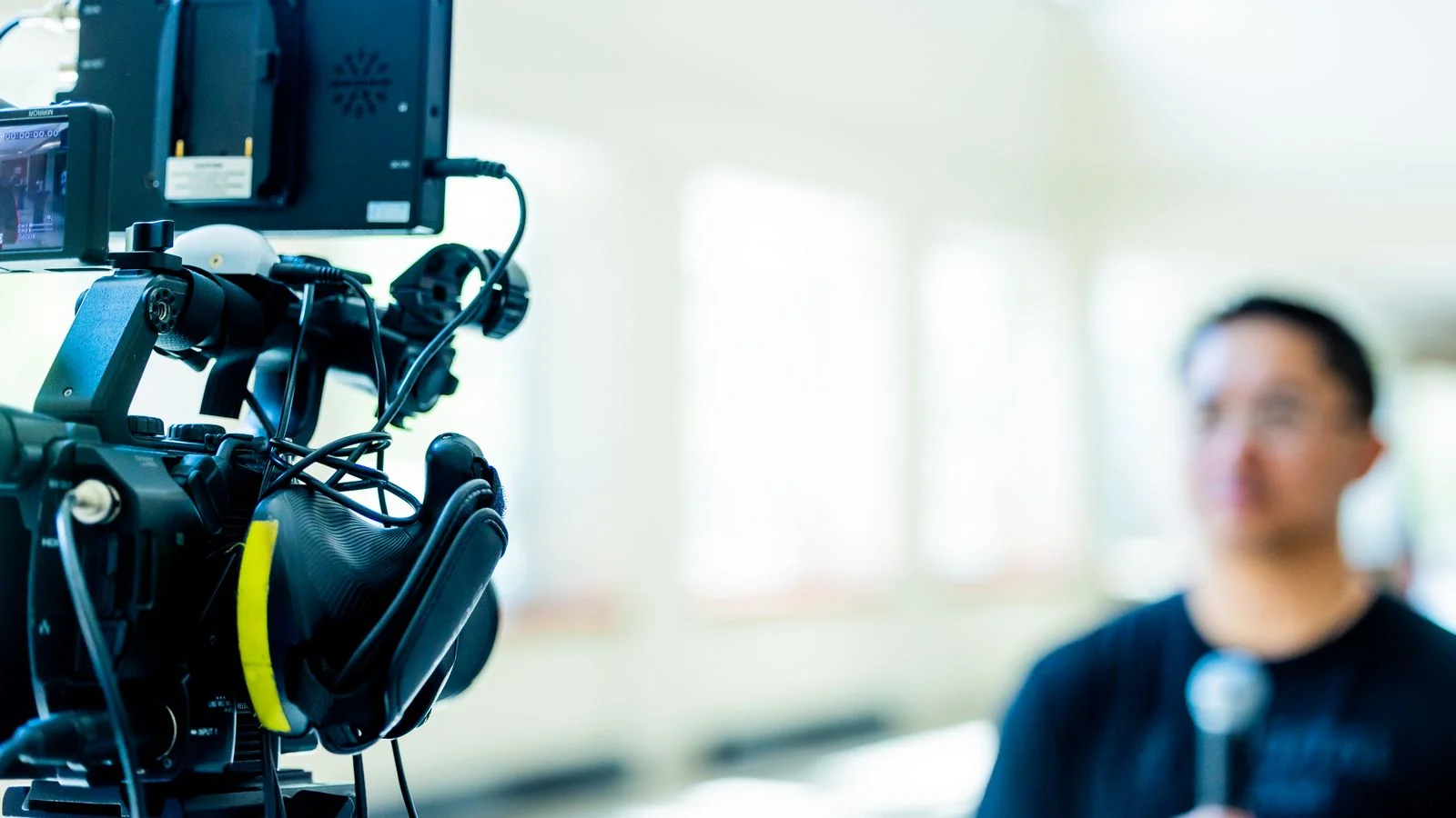 Professional video camera set up to record an on-camera interview in a studio