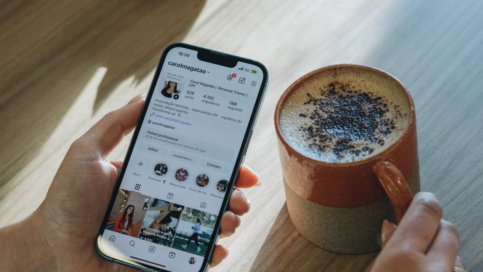 Reader browsing a visual content feed on a phone over morning coffee