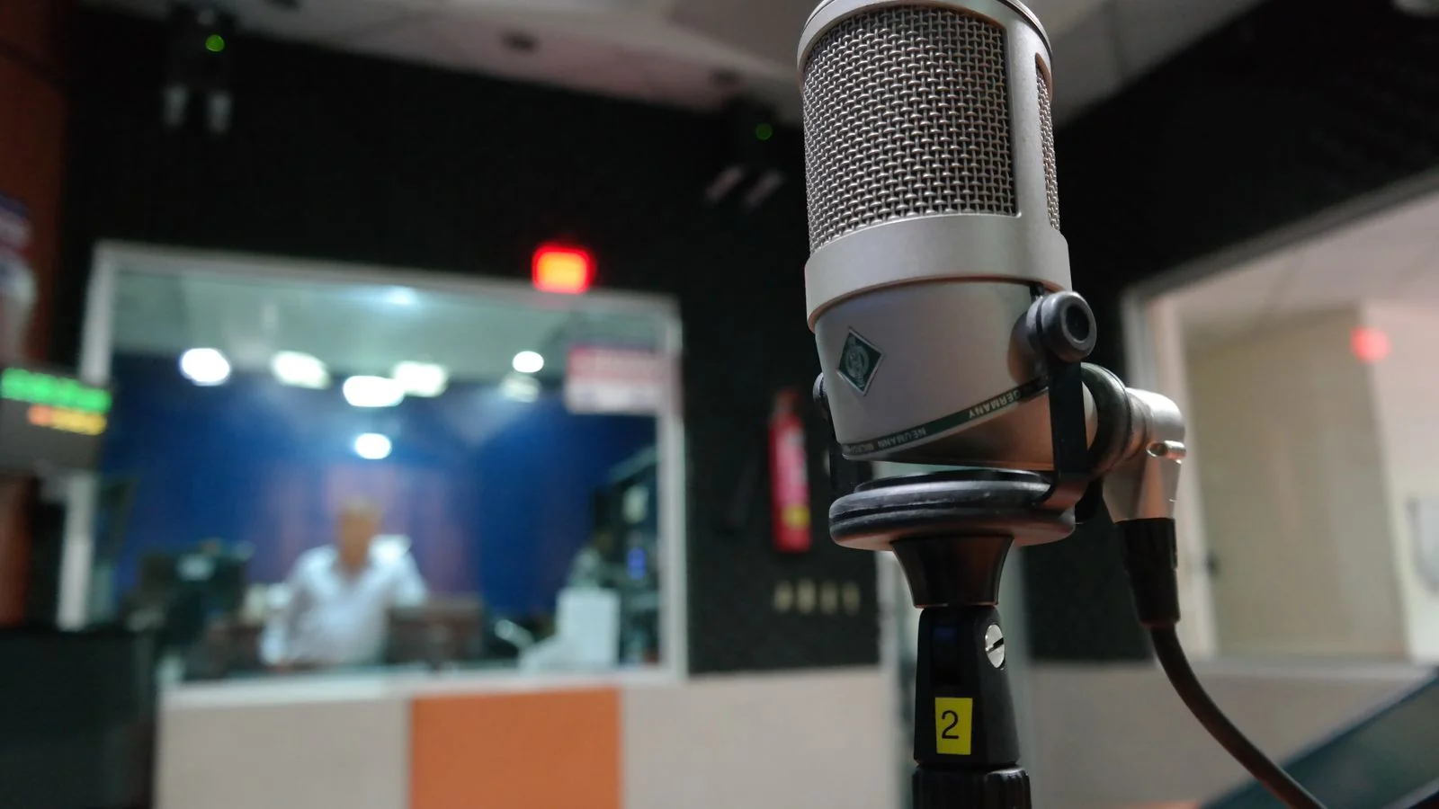 A close-up of a studio microphone, the ten minutes of airtime a producer needs you to fill