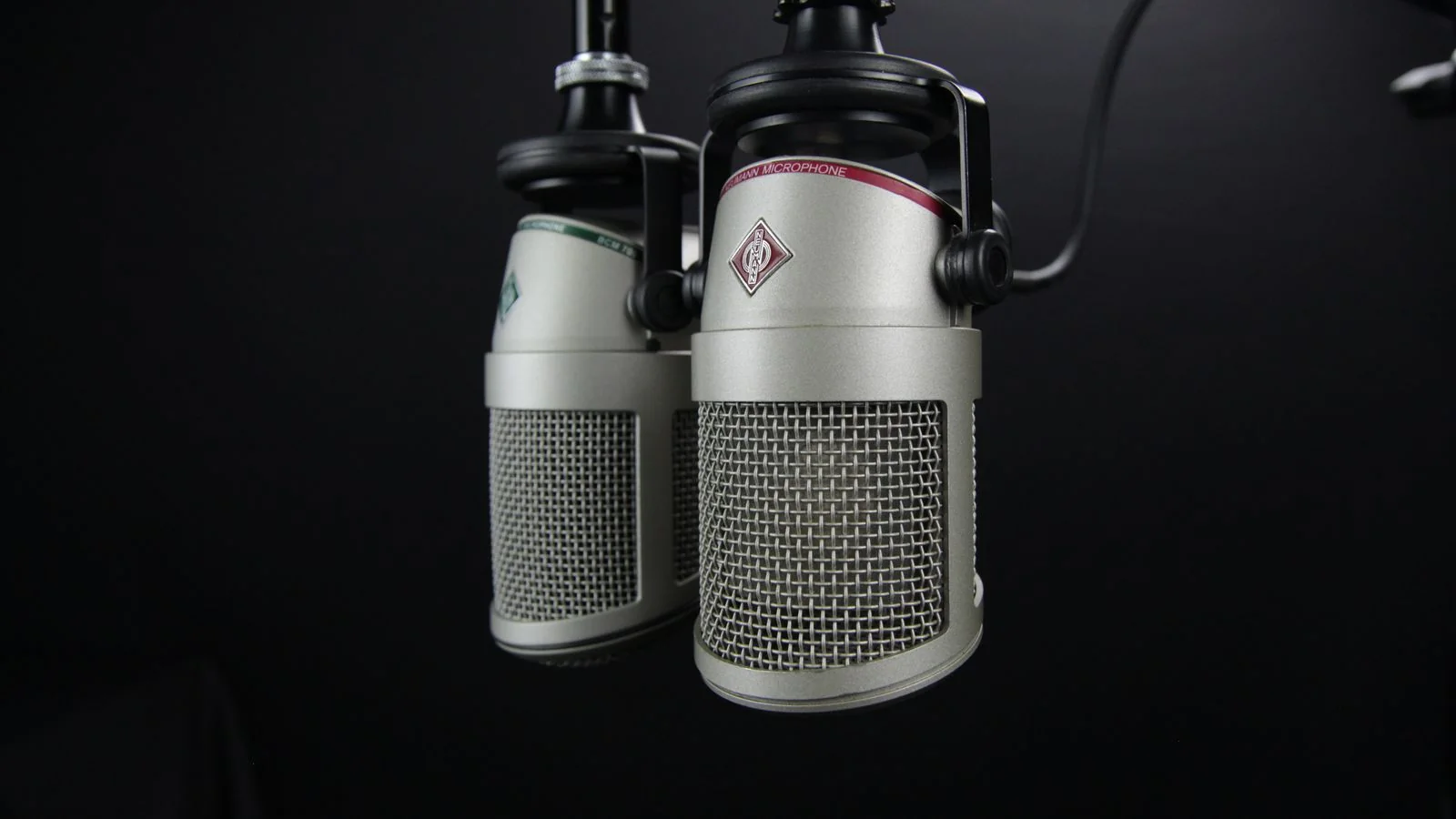 Two studio microphones facing each other, the back-and-forth a strong radio segment is built on