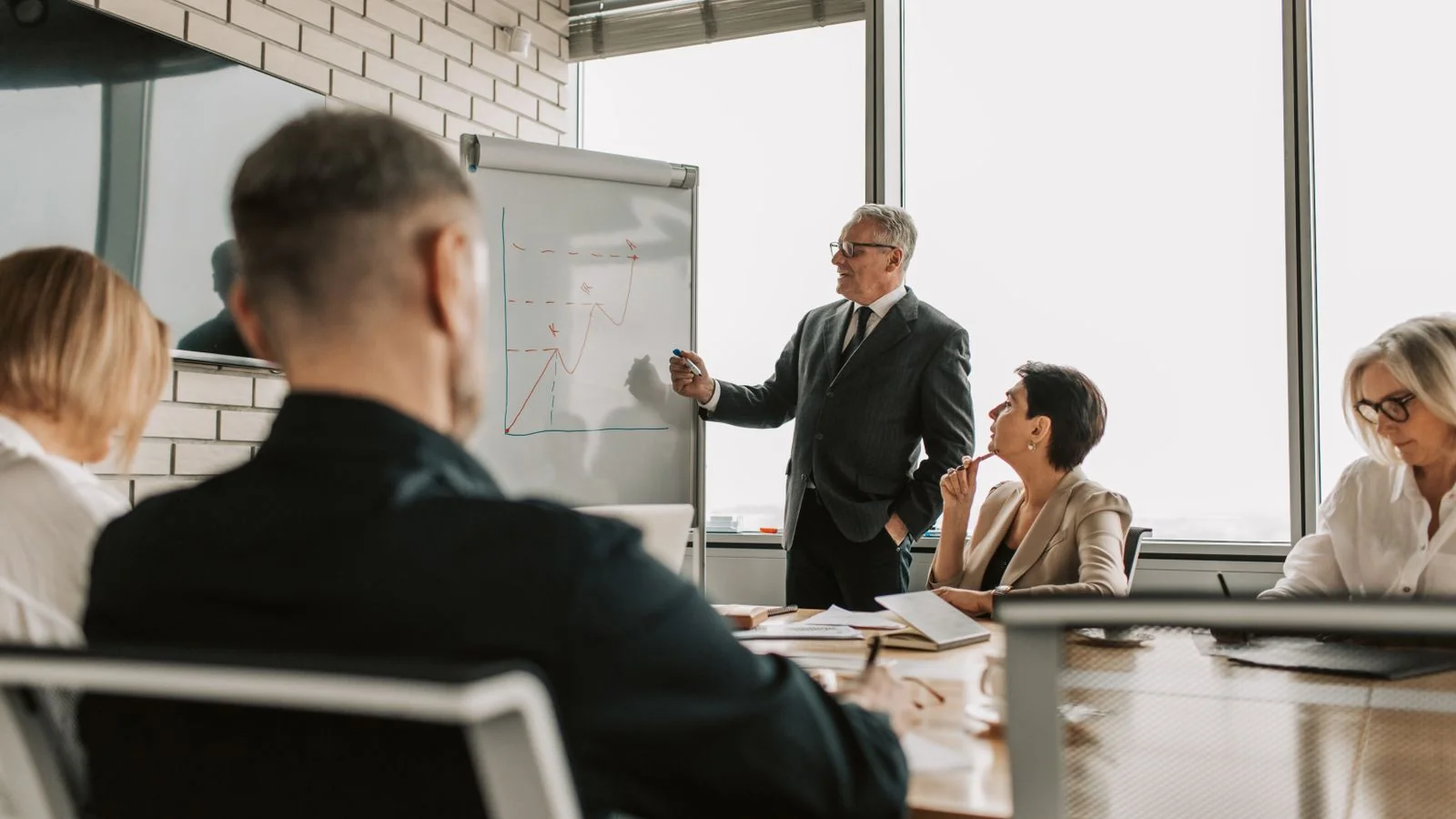 Business partners reviewing a journalist source request together at an office table