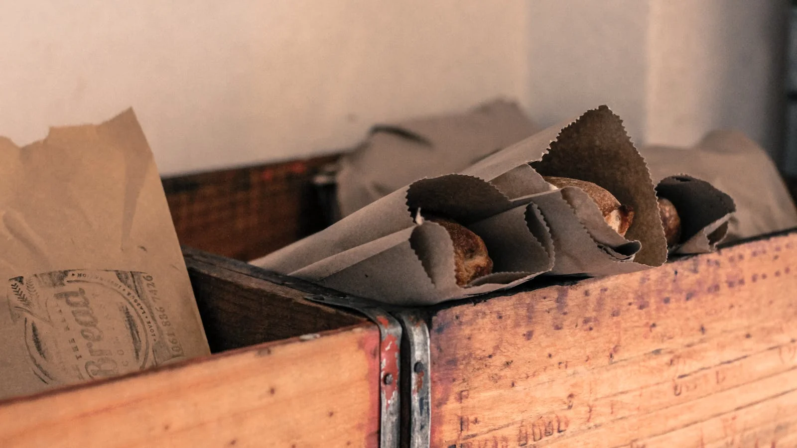 Loaves of artisan bread in kraft paper waiting for the photographer hired by the brand