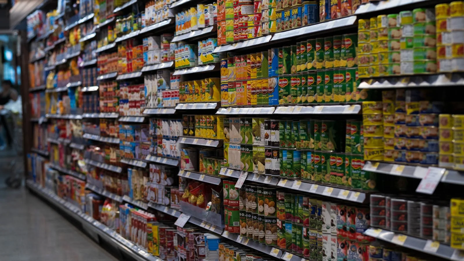 Grocery aisle stacked with canned and packaged goods, the shelf every challenger food brand wants to dominate