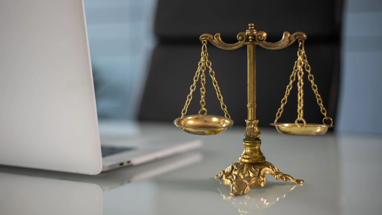 Justice scales beside a laptop, the legal authority reporters want to quote.