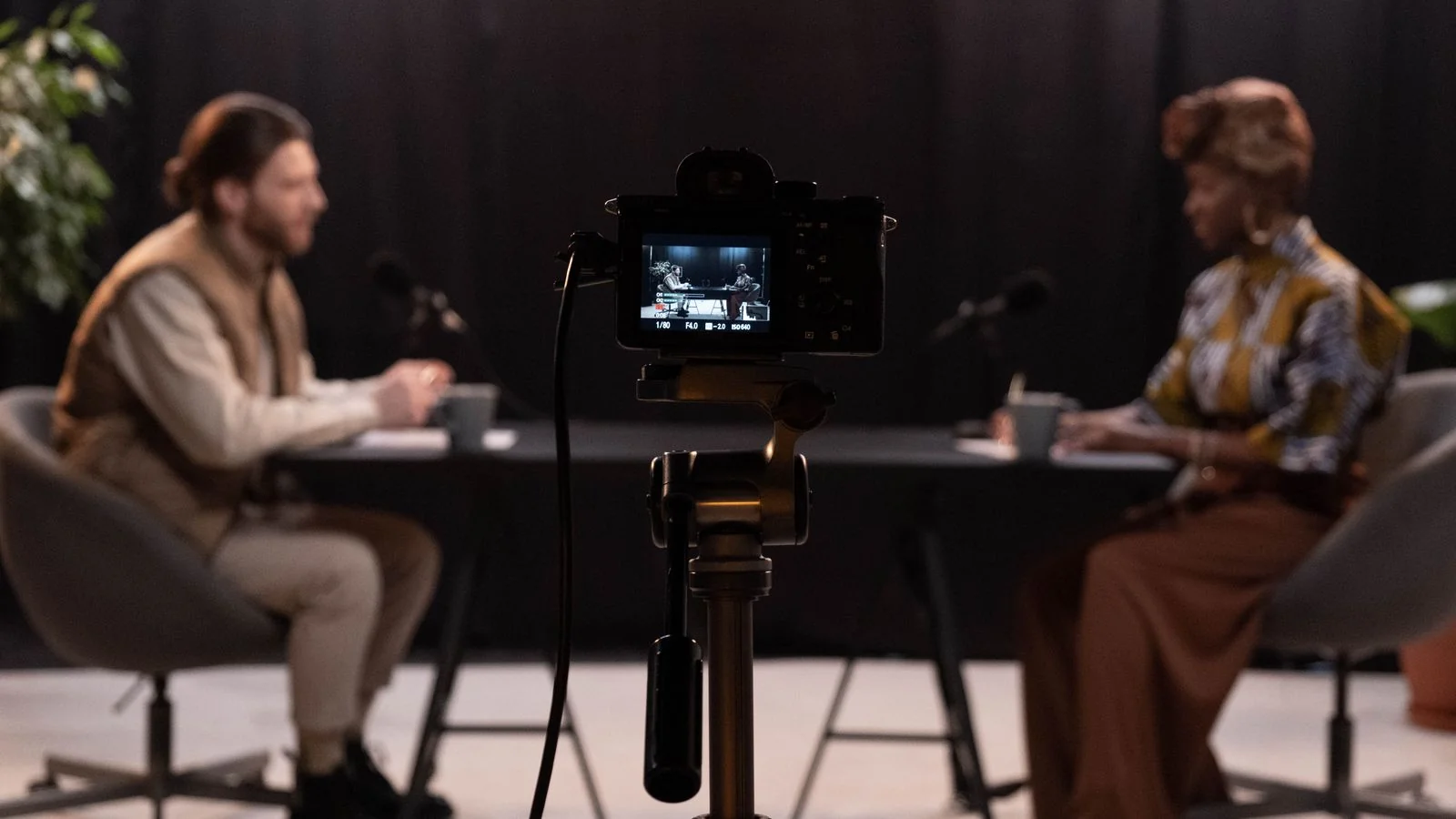 A business owner being interviewed on camera for a media segment.