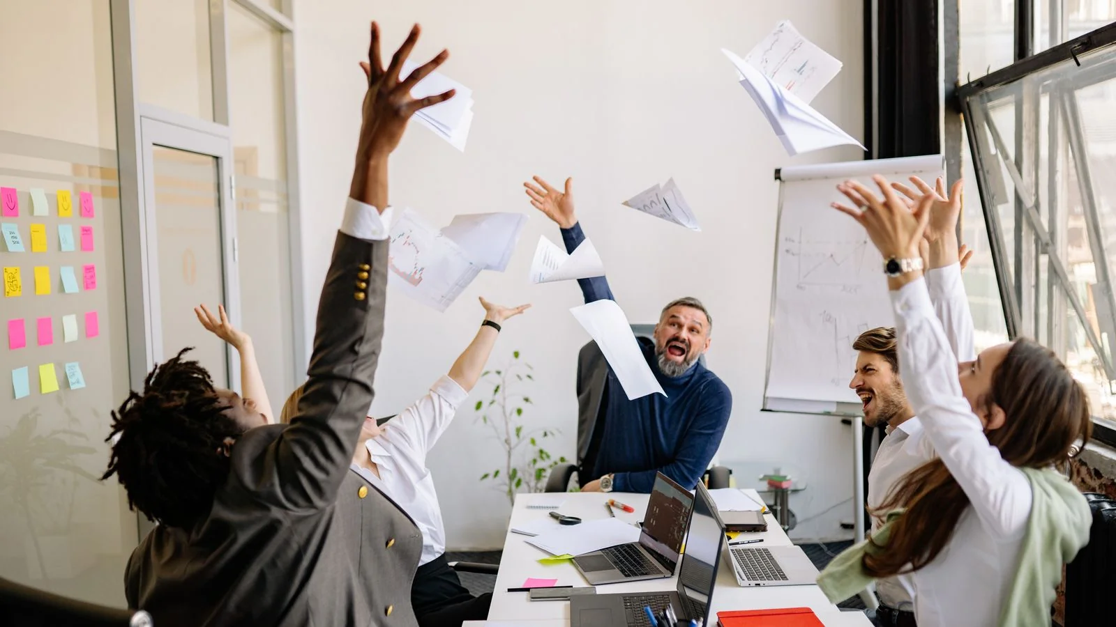 A team celebrating in an office, the outcome every bootcamp wants covered and most describe badly
