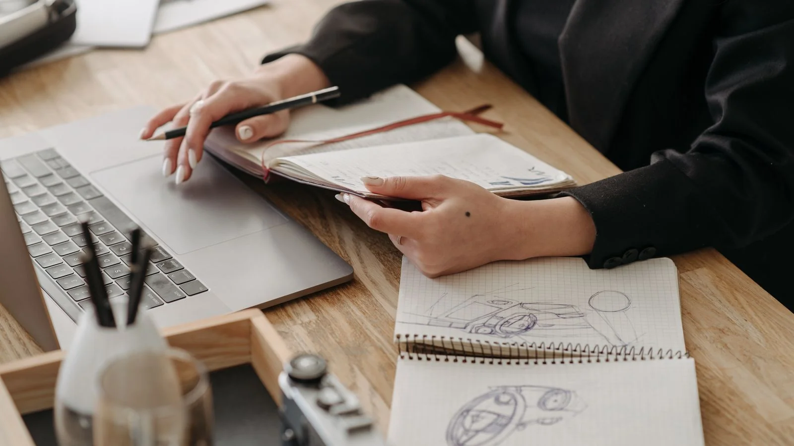 A desk with a laptop and a notebook, where a strong data-backed pitch gets written.