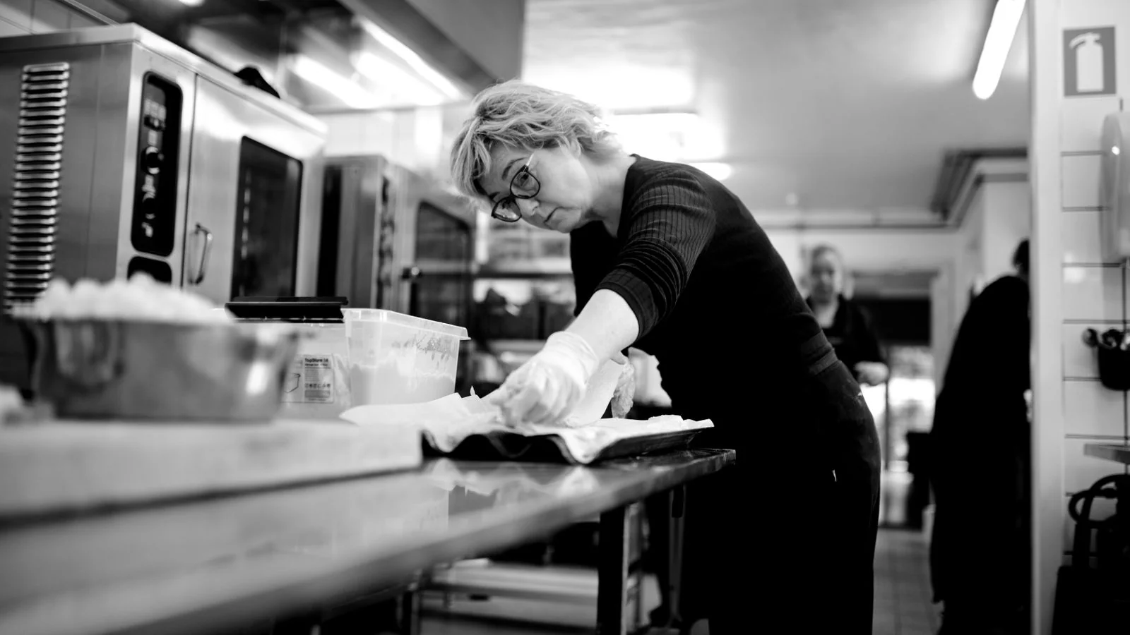 A chef working in a commercial kitchen, where the operational story lives that the product shot never shows.
