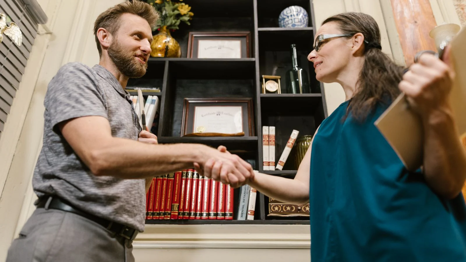 Two people shaking hands in an office, the relationship that follows from being useful before you needed anything
