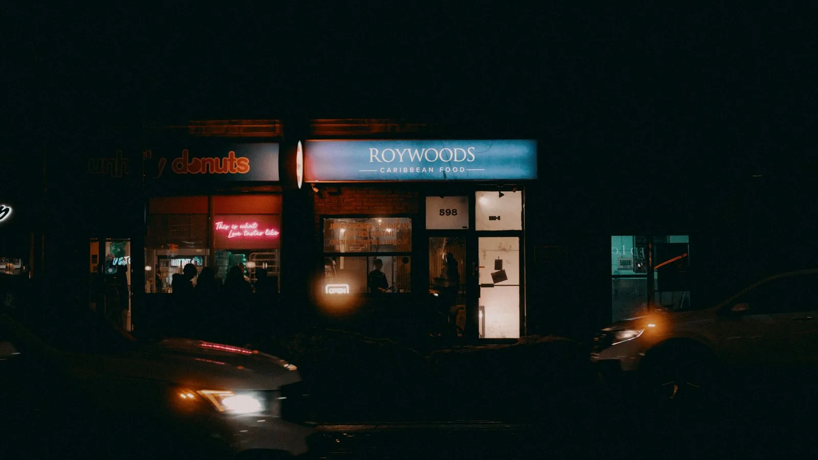 A street glowing with lit shopfront signs, the landmark work that makes a sign company a story.