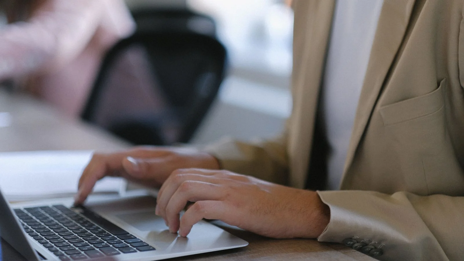 A worker at a laptop in an office, the reporter deciding in eight seconds whether your pitch is a story