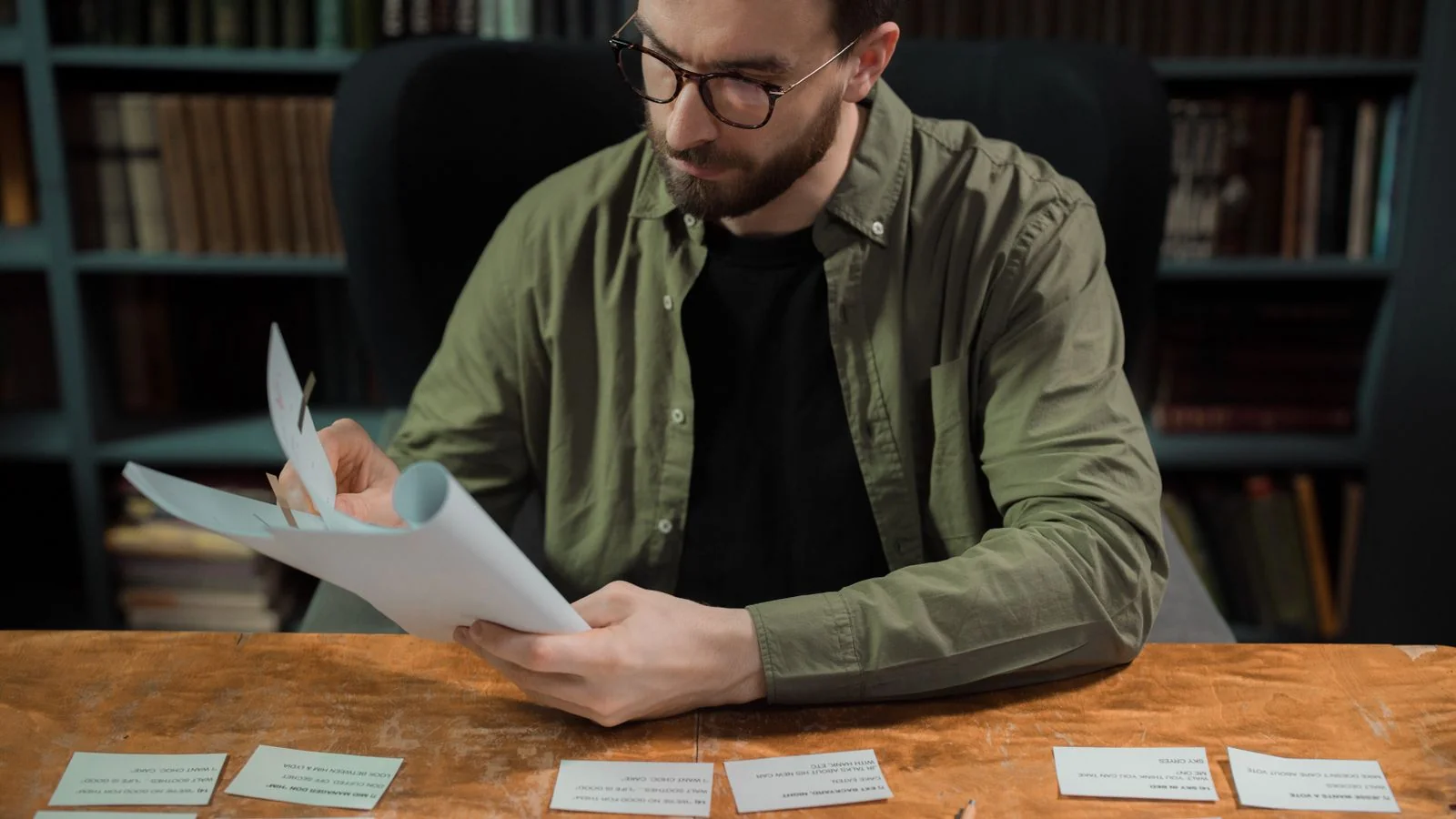 Man studying papers in a library, the practitioner-scholar audience the magazine was built around