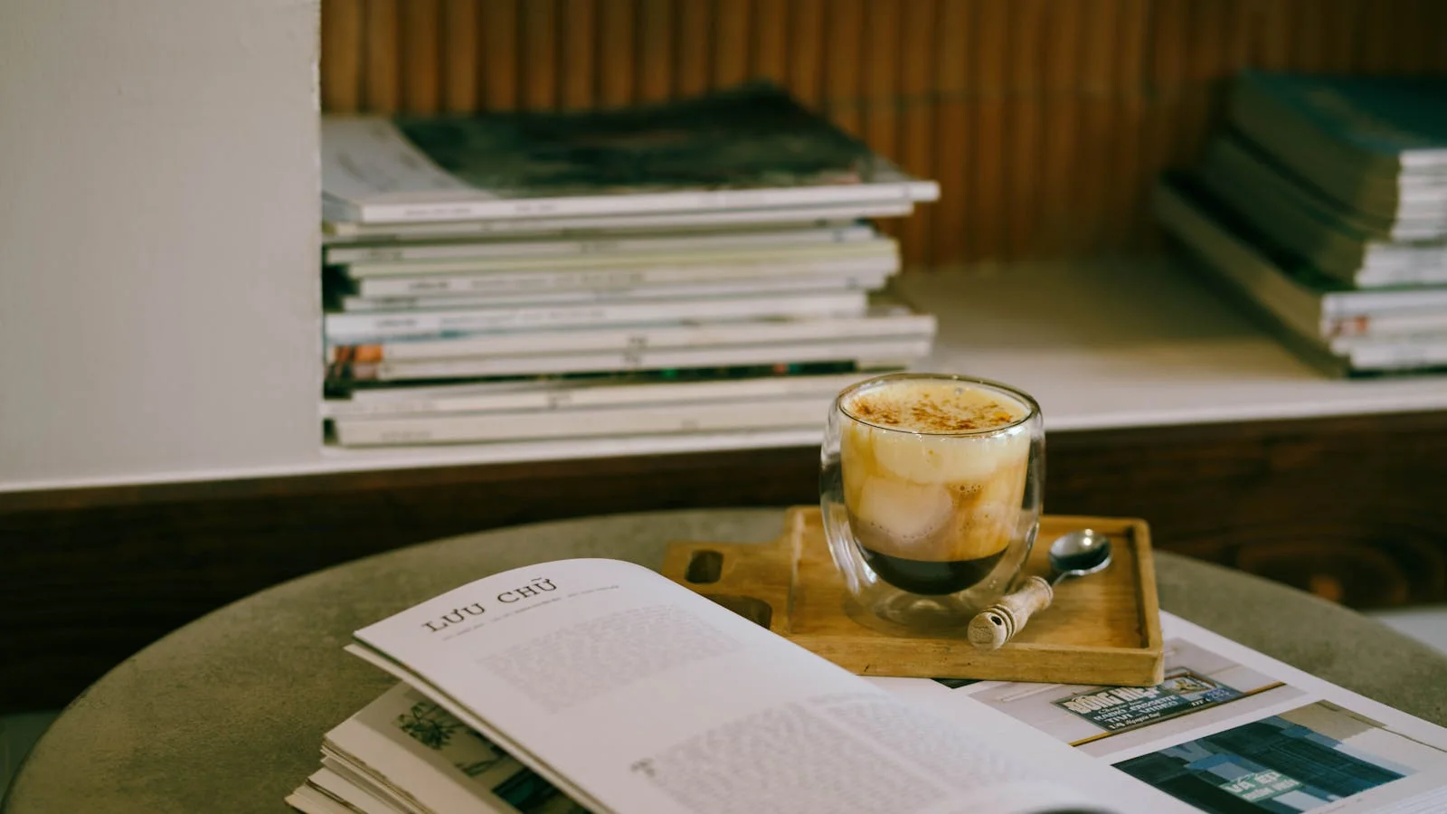 Open scientific journal with reading glasses resting on the page beside a coffee mug, the morning ritual of an editor scanning the field.