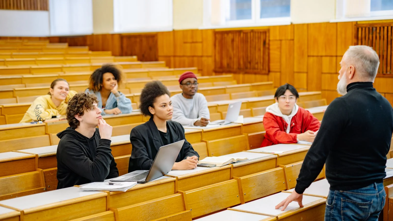 University lecturer engaging students in a diverse classroom discussion