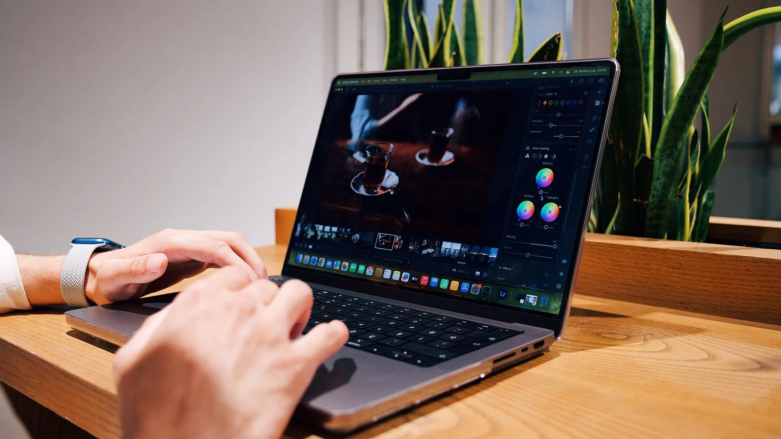 Hands editing content on a laptop in an office, the on-page clarity work that makes an entity legible to Gemini