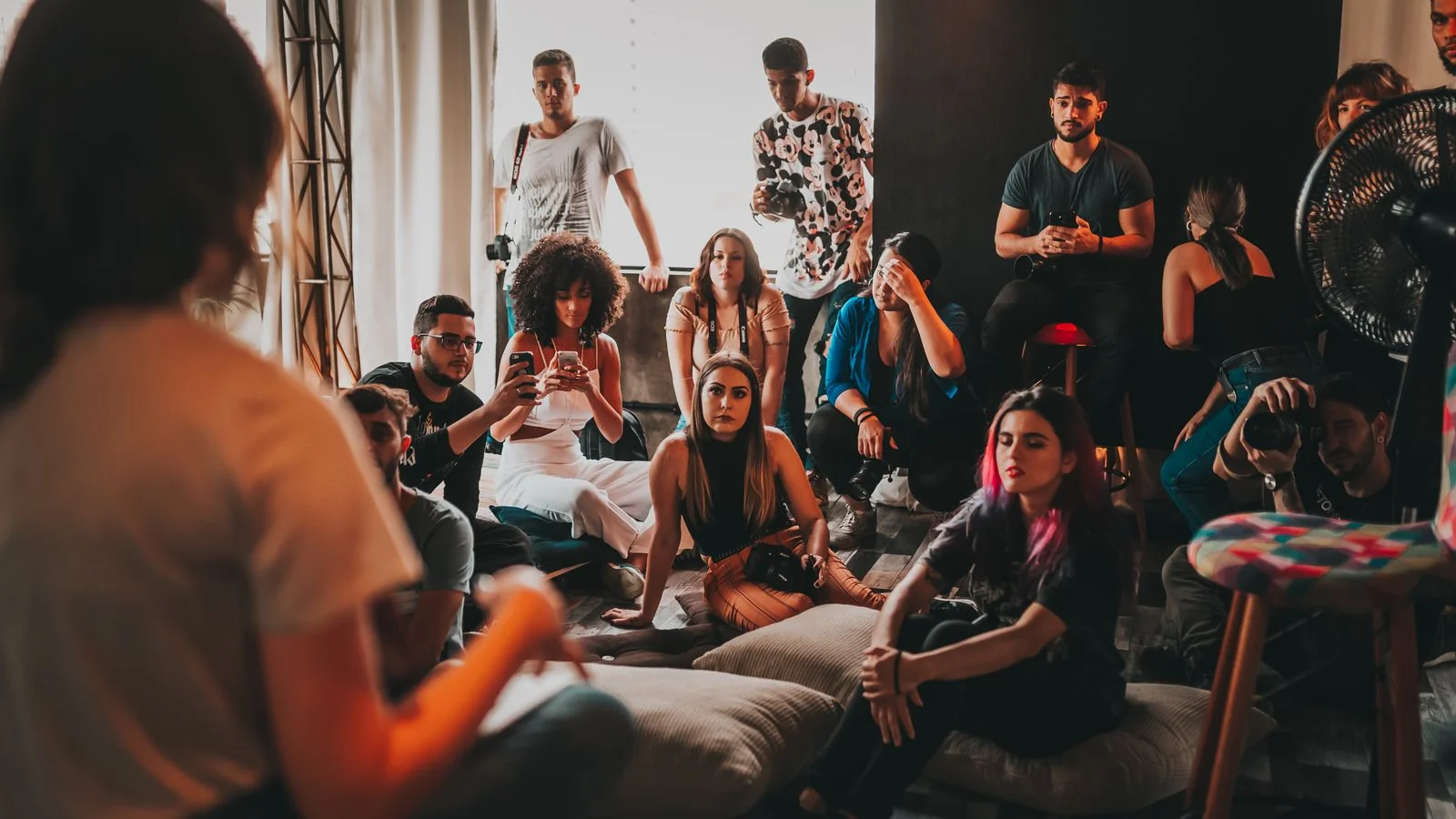 Group of people in a community gathering engaged in discussion about shared interests and recommendations