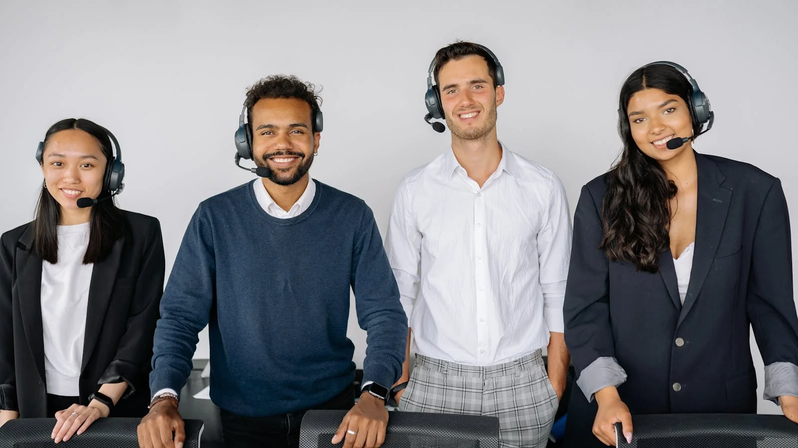 A customer support team wearing headsets, the channel a business uses to report a fake review.