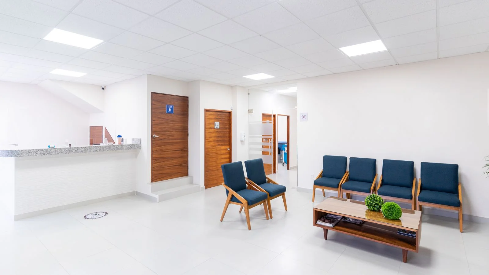 Bright, modern medical waiting room with clean seating, the in-person experience reviews describe