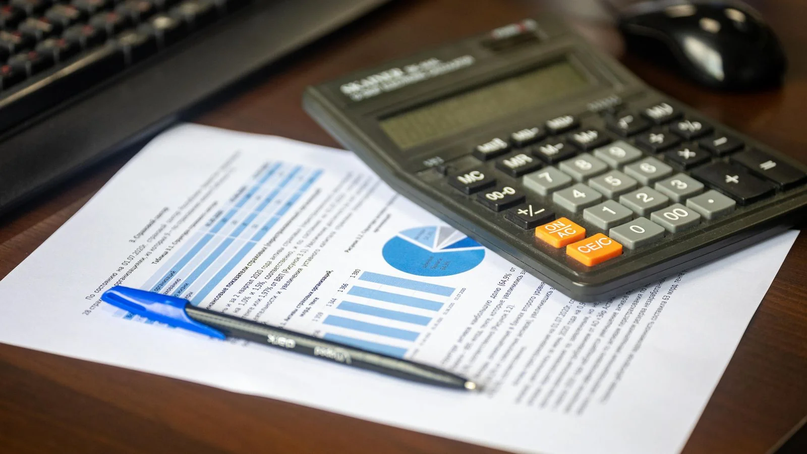 A calculator resting on a printed financial report, the unglamorous core of PR measurement