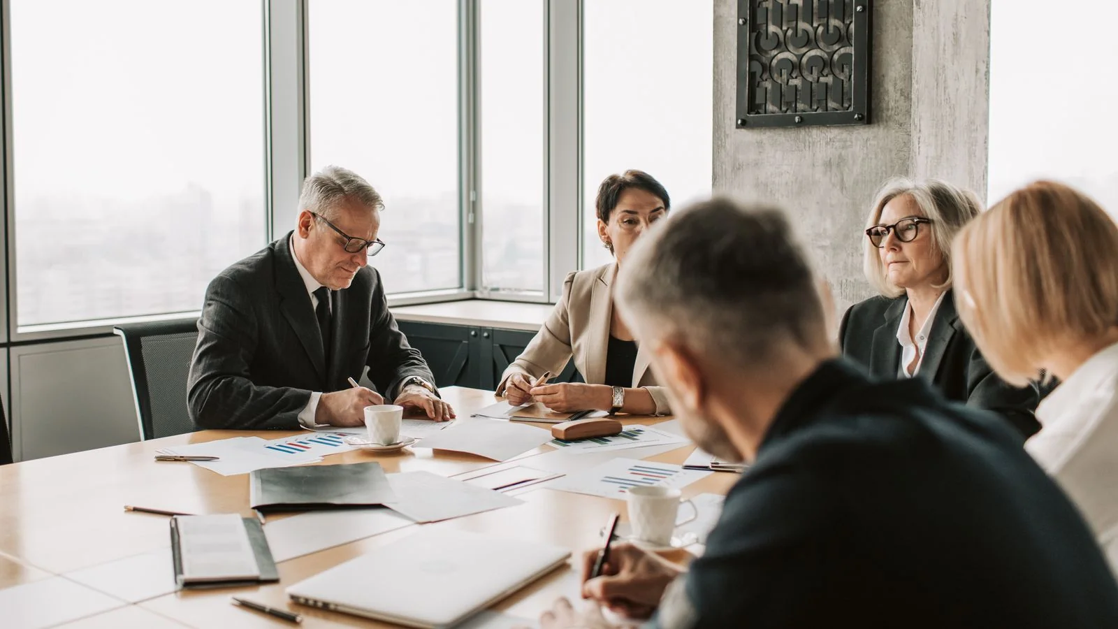 Business professionals reviewing results together in a meeting room.