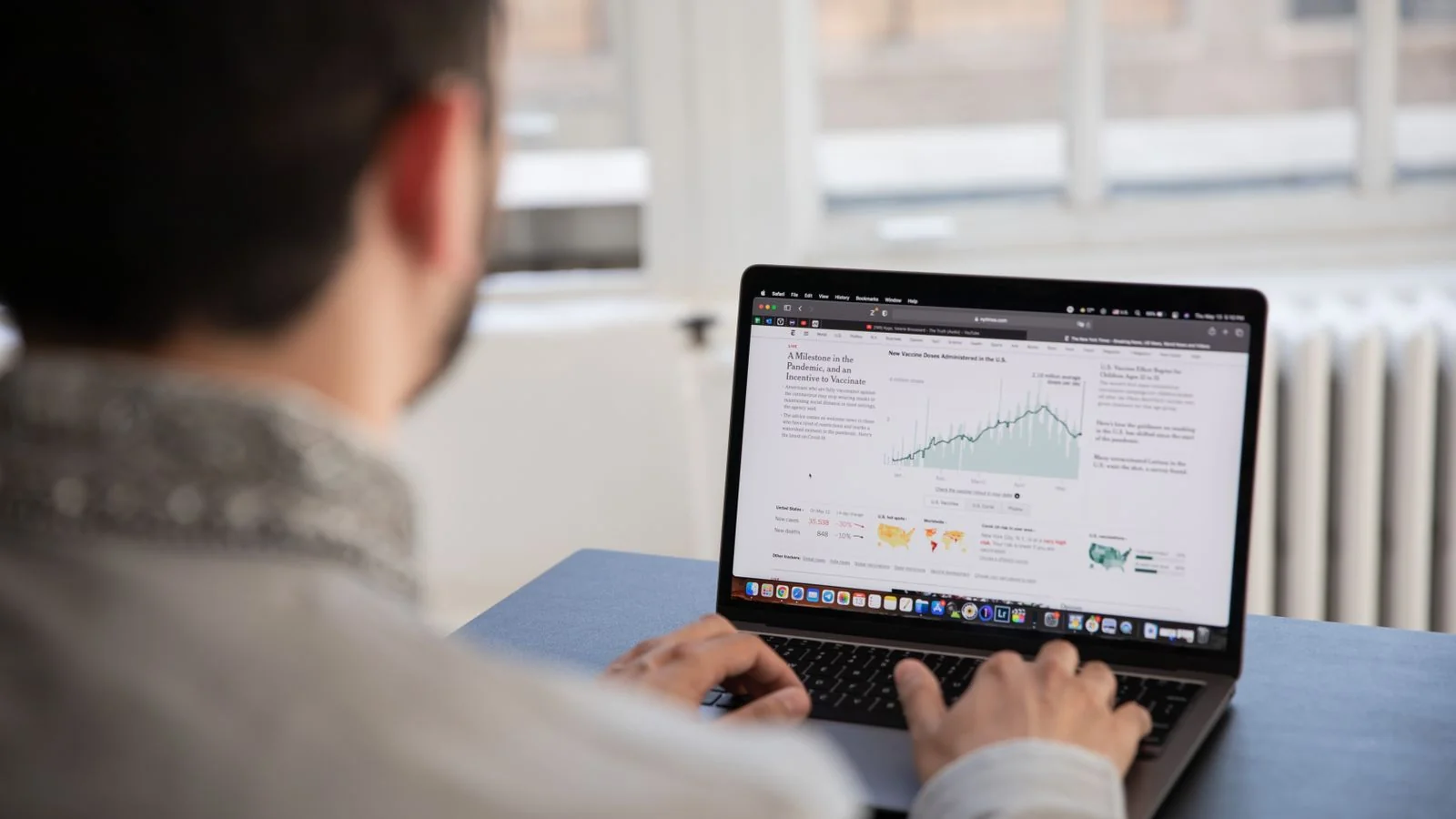 A person checking website analytics on a laptop, the reachability layer at the bottom of the stack