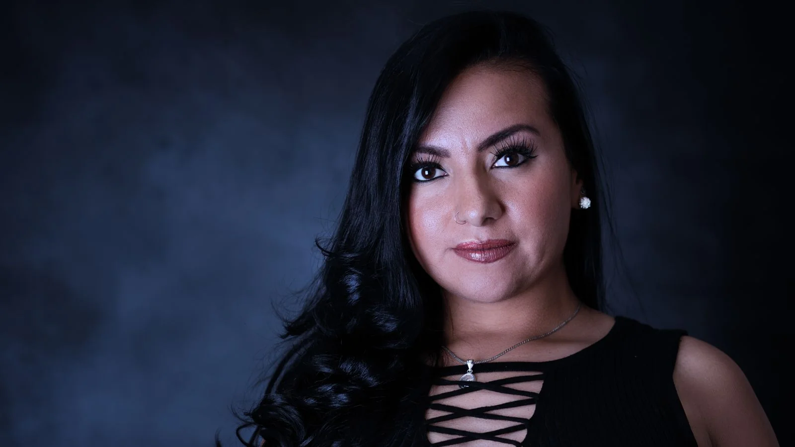 Portrait of a woman against a dark backdrop, the clear identifiable headshot every author page should carry