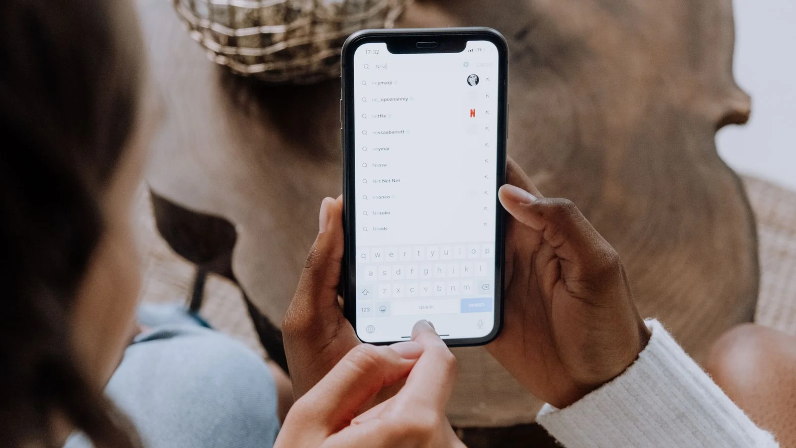 A person searching on a smartphone, the everyday voice and conversational queries businesses now compete for