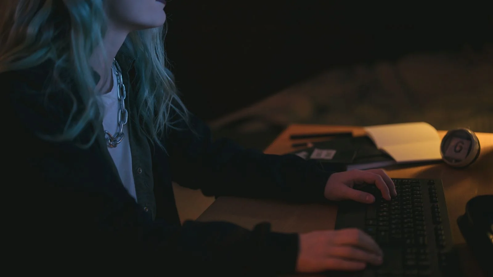 Journalist writing at a desk late at night, the pitch triage that happens after hours