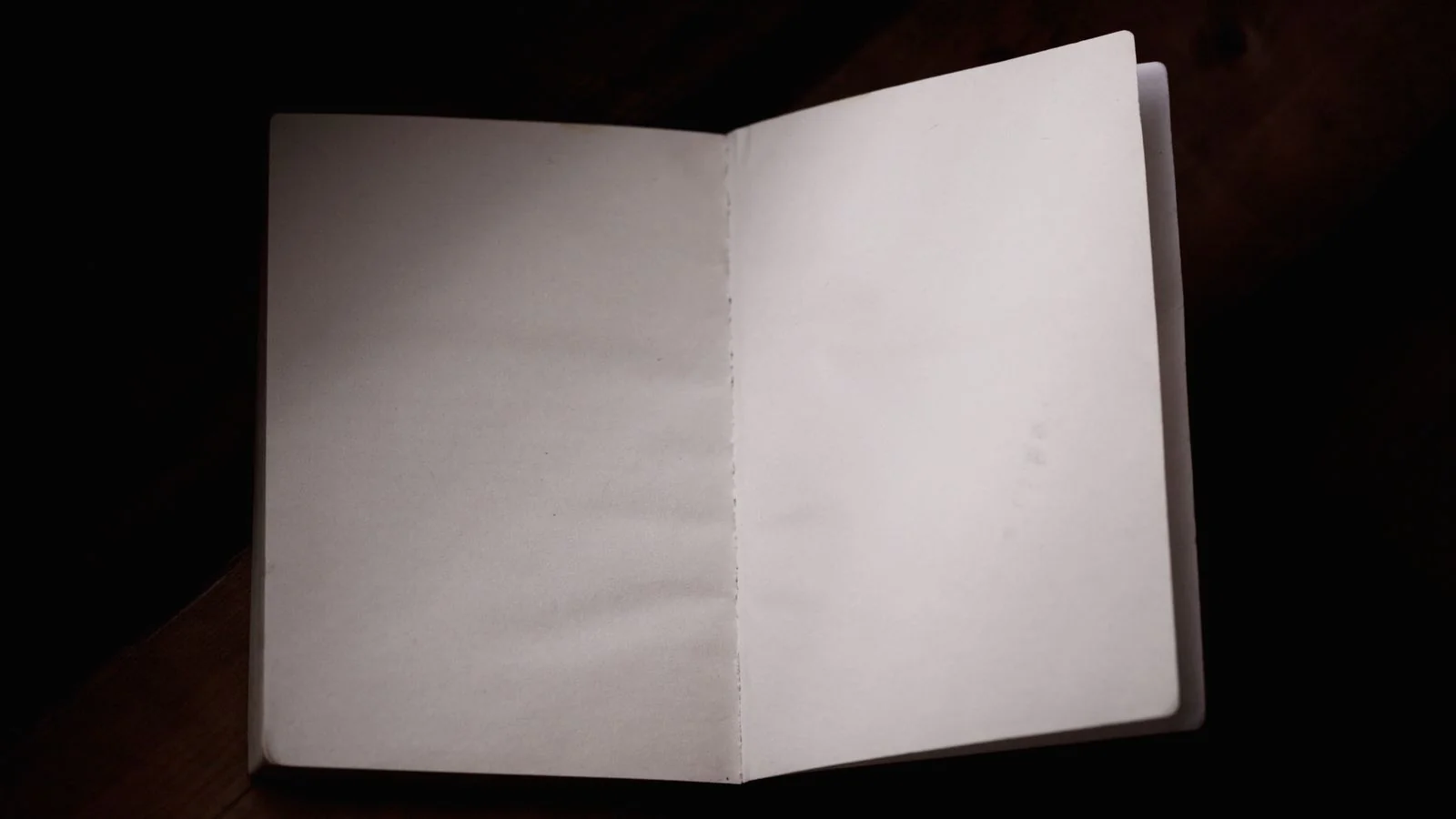An open notebook on a wooden desk, the access notes behind a feature.