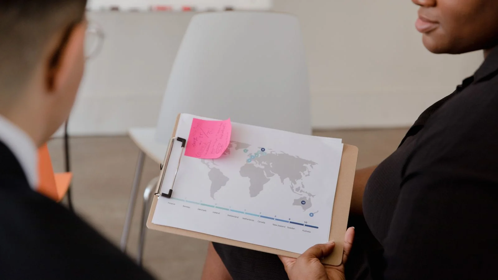 A world map and data on a clipboard, the systems-level view Quartz stories are built from
