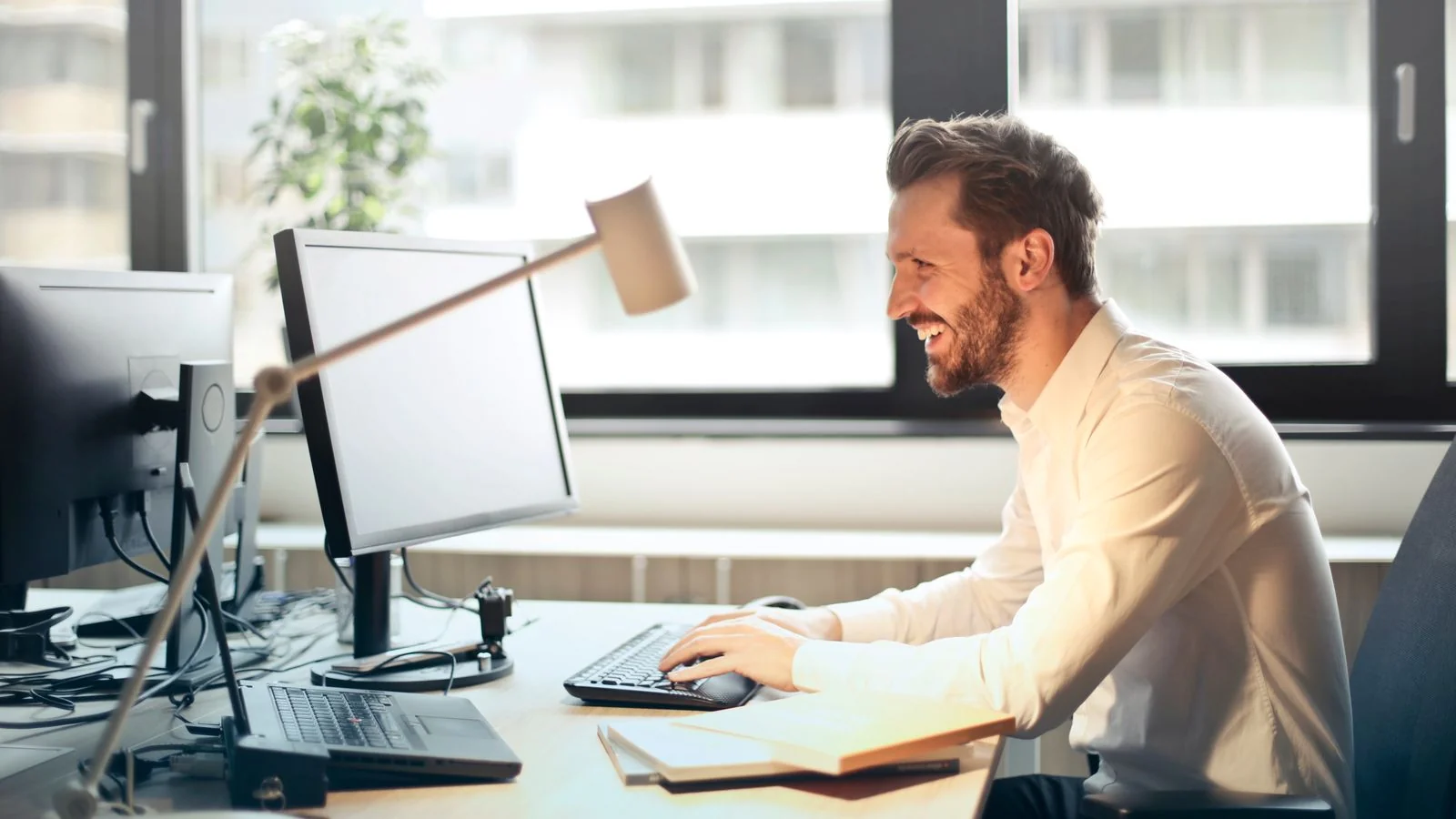 Working at a desk with natural light, the follow-up call that turns a topic into a pitch