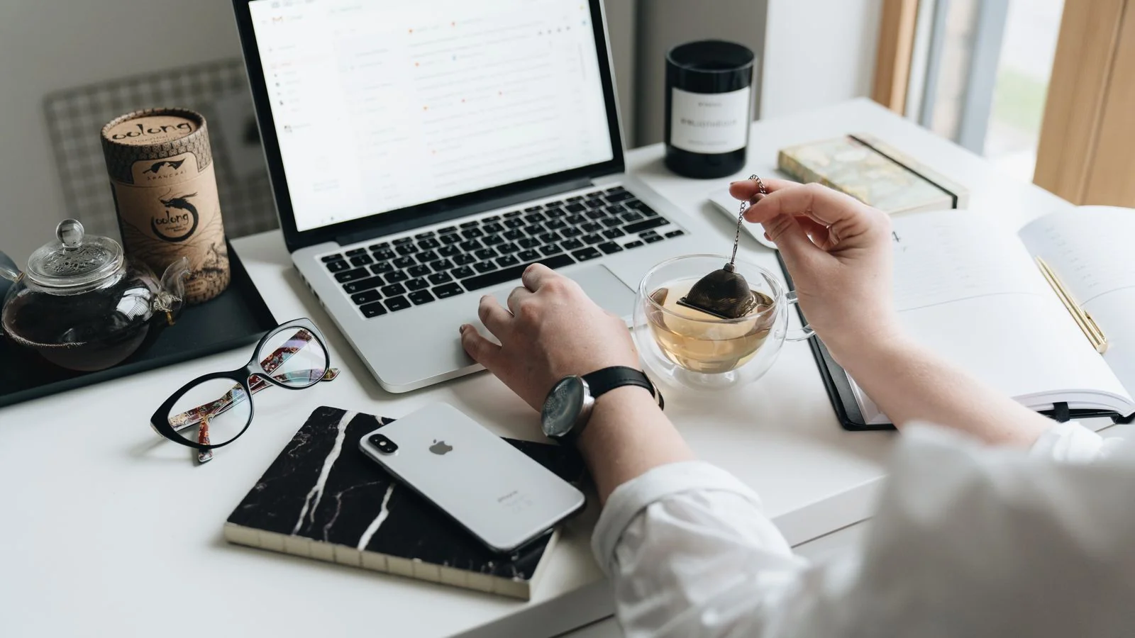 A laptop and morning tea at a home desk, where Semafor's beat newsletters actually get read