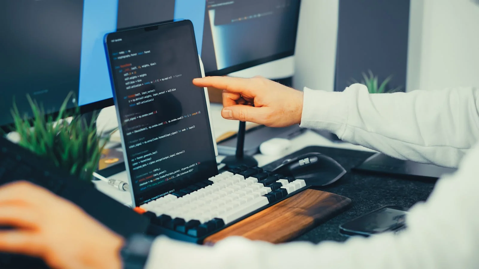 A developer's laptop and monitor showing code, the kind of product tech reporters cover