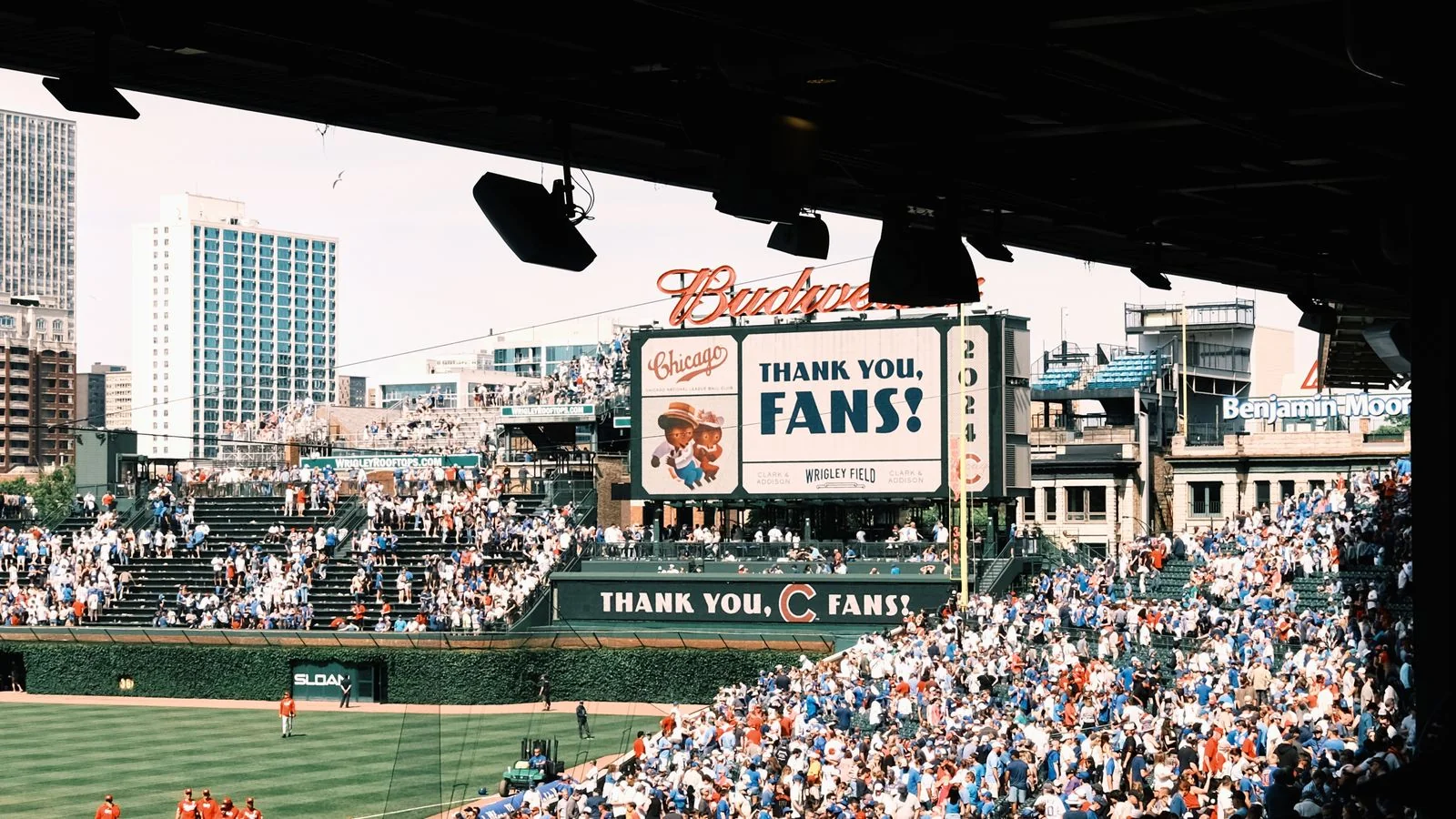 Large crowd of fans filling the stands at a baseball game at Wrigley Field