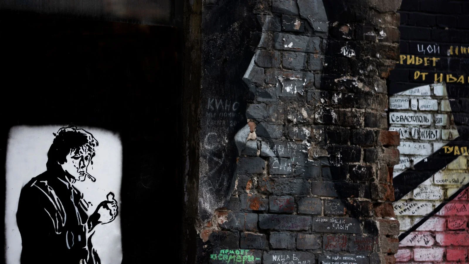 Street art and graffiti layered on a brick wall, the kind of scene a Vice feature gets built around