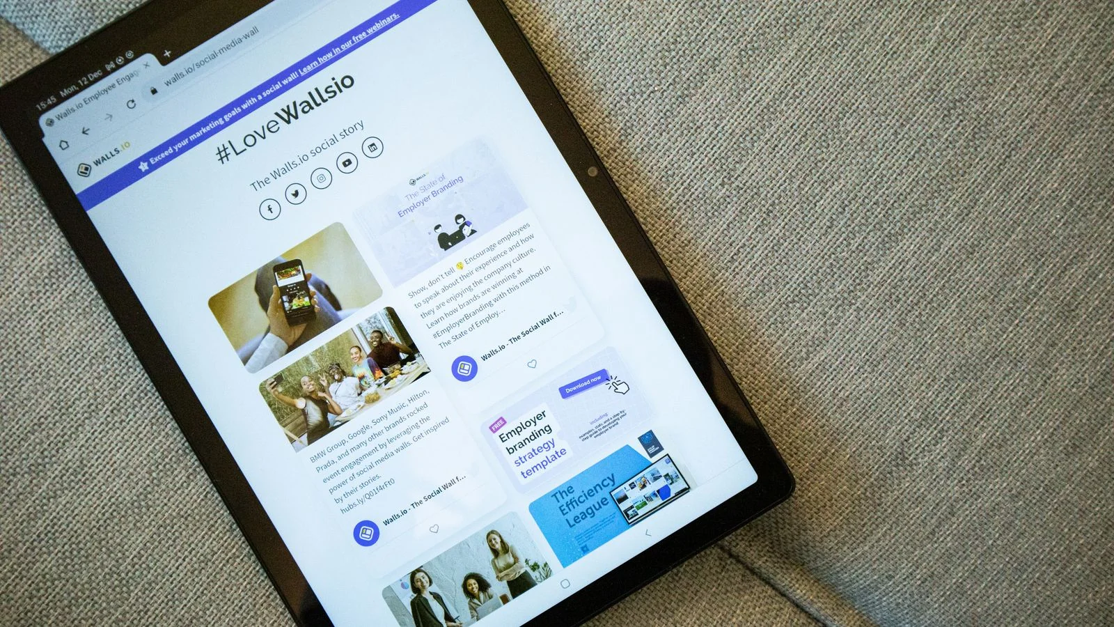 Tablet resting on a couch, displaying a personal website builder interface