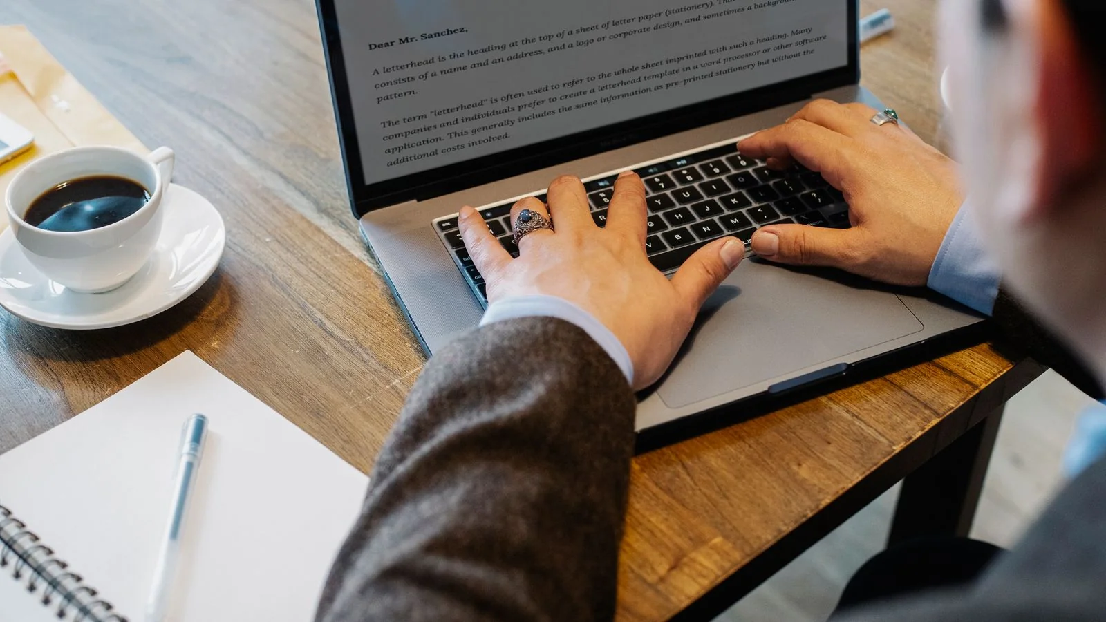 A writer working at a laptop, the steady content work that climbs the retrieval rung of the recall ladder